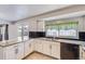 Updated eat-in kitchen featuring granite counters, stainless appliances, subway tile and access to the backyard at 7814 W Ontario Pl, Littleton, CO 80128