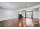Spacious living room features hardwood floors, a dark brick fireplace, recessed lighting, and a bright window at 7814 W Ontario Pl, Littleton, CO 80128