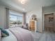 Bedroom with large windows, plush carpeting, and a stylish dresser with mirror at 21947 E 51St Dr, Aurora, CO 80019
