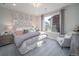 Inviting bedroom with decorative headboard, accent pillows, and a cozy sitting area at 21947 E 51St Dr, Aurora, CO 80019