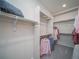 Walk-in closet featuring built-in shelving and hanging rods for organized storage at 21947 E 51St Dr, Aurora, CO 80019