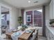 Dining room with a wood table, stylish chairs, natural light, and view of the exterior at 21947 E 51St Dr, Aurora, CO 80019
