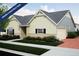 New construction home showcasing a two-car garage, board and batten siding, and a manicured lawn at 21947 E 51St Dr, Aurora, CO 80019