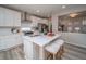 Well-lit kitchen featuring a white countertop island with stools and modern appliances at 21947 E 51St Dr, Aurora, CO 80019