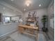 Open home office with a desk, shelving, view into the kitchen and dining room at 21947 E 51St Dr, Aurora, CO 80019