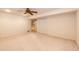 Spacious basement with neutral carpet, ceiling fan and storage closet at 20576 E Caley Dr, Centennial, CO 80016