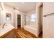 Well-lit bathroom showcasing a tub, a glass shower, and double sinks at 20576 E Caley Dr, Centennial, CO 80016