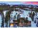 Luxury home in snowy mountain setting at sunset at 457 Timber Trail Rd, Breckenridge, CO 80424