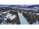 Aerial view of home in snowy mountain setting, near ski slope at 457 Timber Trail Rd, Breckenridge, CO 80424