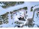 Bird's-eye view of a home nestled in snowy trees with driveway access at 457 Timber Trail Rd, Breckenridge, CO 80424