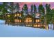 Large luxury home with mountain views at dusk at 457 Timber Trail Rd, Breckenridge, CO 80424