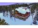 Luxury home with snowy roof, nestled in a snowy mountain setting at 457 Timber Trail Rd, Breckenridge, CO 80424