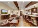 Finished basement with a wet bar, seating area, and a large TV at 457 Timber Trail Rd, Breckenridge, CO 80424