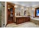 Bathroom with double sinks, a walk-in closet, and a soaking tub at 457 Timber Trail Rd, Breckenridge, CO 80424