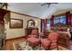 Bedroom with a large bed, red chairs, and a stunning landscape painting at 457 Timber Trail Rd, Breckenridge, CO 80424