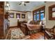 Comfortable bedroom with a sleigh bed and a cozy sitting area near the fireplace at 457 Timber Trail Rd, Breckenridge, CO 80424