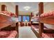 Bunk room with multiple beds and forest views at 457 Timber Trail Rd, Breckenridge, CO 80424