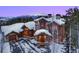Luxury home with mountain views, snow covered roof, and attached garage at 457 Timber Trail Rd, Breckenridge, CO 80424