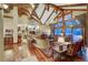 Spacious living room with vaulted ceilings, hardwood floors, and a stone fireplace at 457 Timber Trail Rd, Breckenridge, CO 80424