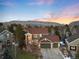 Gorgeous aerial view of a two-story home with a three car garage nestled in a serene neighborhood with mountain views at 6 White Alder, Littleton, CO 80127