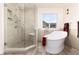 Bathroom with separate tub and shower, neutral tile, and recessed lighting at 6 White Alder, Littleton, CO 80127