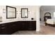 Bathroom featuring double sink vanity with marble counters and wood-look tile floors at 6 White Alder, Littleton, CO 80127