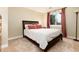 Comfortable bedroom with a large bed, plush pillows, and a window with bright red curtains at 6 White Alder, Littleton, CO 80127