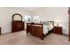 Bedroom with neutral carpet, wood furnishings, and two windows with views at 6 White Alder, Littleton, CO 80127