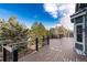 Beautiful outdoor deck with black railings and a scenic view of the surrounding landscape and lush trees at 6 White Alder, Littleton, CO 80127