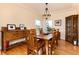 Bright dining room with hardwood floors, a decorative chandelier, and ample natural light at 6 White Alder, Littleton, CO 80127