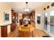 Open dining room featuring wood table set and easy access to outdoor deck and modern kitchen at 6 White Alder, Littleton, CO 80127