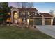 Beautiful two-story home featuring a three-car garage, brick accents, professional landscaping, and a welcoming front entrance at 6 White Alder, Littleton, CO 80127