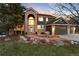 Charming two-story home with brick accents, manicured lawn, mature trees, and a three-car garage at 6 White Alder, Littleton, CO 80127