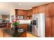 Open kitchen featuring stainless appliances, wine cooler, granite countertops, and cherry wood cabinets at 6 White Alder, Littleton, CO 80127