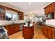 Open kitchen featuring cherry wood cabinets, granite countertops, stainless appliances, and central island at 6 White Alder, Littleton, CO 80127