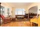 Cozy living room with a large window, hardwood floors, neutral paint, and comfortable seating at 6 White Alder, Littleton, CO 80127