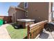 Private backyard featuring a covered hot tub with artificial grass, offering a relaxing outdoor space at 1334 Barberry Trl, Elizabeth, CO 80107