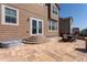 Paver patio with steps and an outdoor table, creating an inviting and stylish outdoor space at 1334 Barberry Trl, Elizabeth, CO 80107