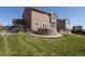 Spacious backyard with a lush green lawn, a patio, and play equipment for Gathering enjoyment at 1334 Barberry Trl, Elizabeth, CO 80107