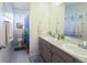 Bright bathroom with double vanity and nautical-themed decor and art at 1334 Barberry Trl, Elizabeth, CO 80107