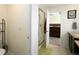 Light-filled bathroom with neutral tile, glass shower, and doorway into the primary bedroom at 1334 Barberry Trl, Elizabeth, CO 80107