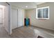 Bright bedroom with light hardwood floors, a basement window, and closet with sliding doors at 1334 Barberry Trl, Elizabeth, CO 80107