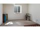 Bright bedroom featuring a basement window, light hardwood floors, and neutral walls at 1334 Barberry Trl, Elizabeth, CO 80107