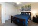 Comfortable bedroom featuring a dark wood frame bed with bright natural light and a ceiling fan at 1334 Barberry Trl, Elizabeth, CO 80107