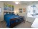 Comfortable bedroom featuring a dark wood frame bed with bright natural light and a ceiling fan at 1334 Barberry Trl, Elizabeth, CO 80107
