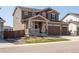 Well-maintained two-story home with a three-car garage, front porch, and nicely landscaped yard at 1334 Barberry Trl, Elizabeth, CO 80107