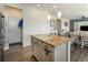 Bright kitchen features a large island with stone countertops and stainless steel appliances at 1334 Barberry Trl, Elizabeth, CO 80107
