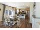 Open kitchen and dining area featuring a kitchen island, stainless appliances, and wood floors at 1334 Barberry Trl, Elizabeth, CO 80107