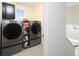Laundry room with modern washer and dryer units next to a window at 1334 Barberry Trl, Elizabeth, CO 80107