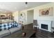Spacious living room with wood floors, fireplace, and seamless flow into kitchen and dining area at 1334 Barberry Trl, Elizabeth, CO 80107